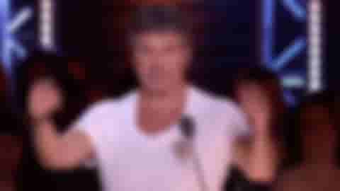 A gif of Simon Cowell putting his fingers in his ears and closing his eyes, representing the concept of ignoring something completely