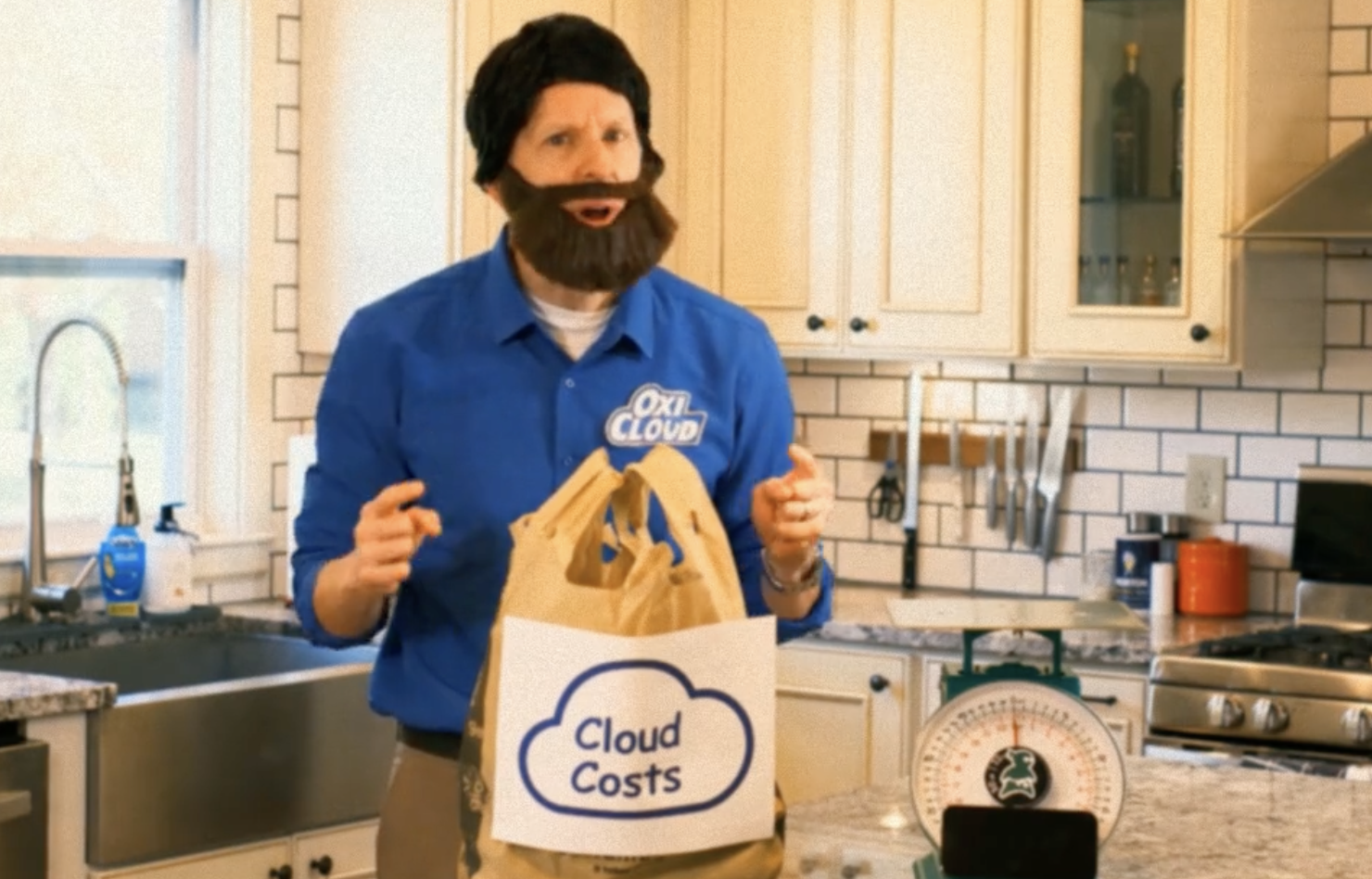 A still from the Judo Scale commercial, featuring Adam dressed like Billy Mays and delivering an infomercial-style pitch in true comedic gold